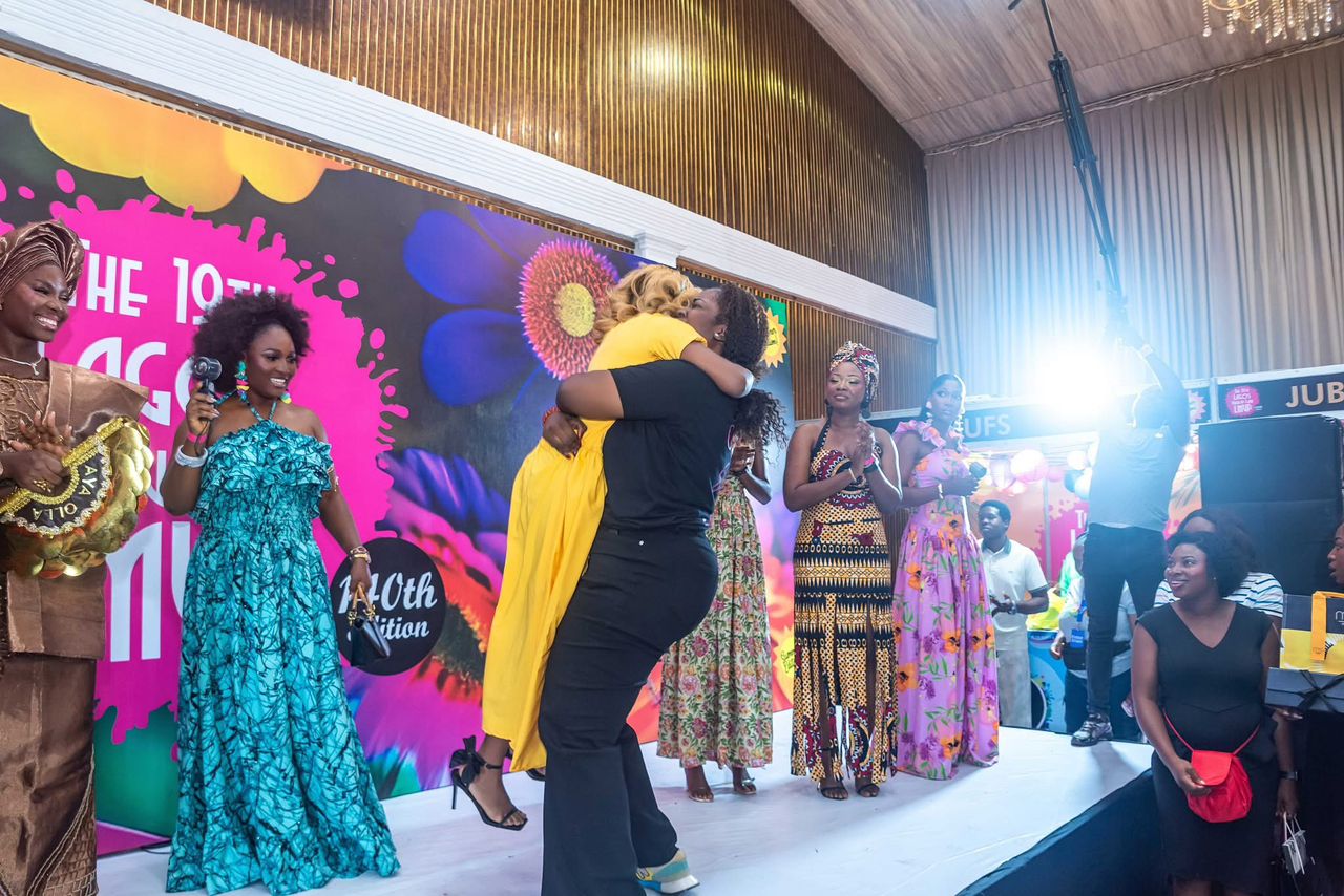 Organisers embracing a winning artist on stage