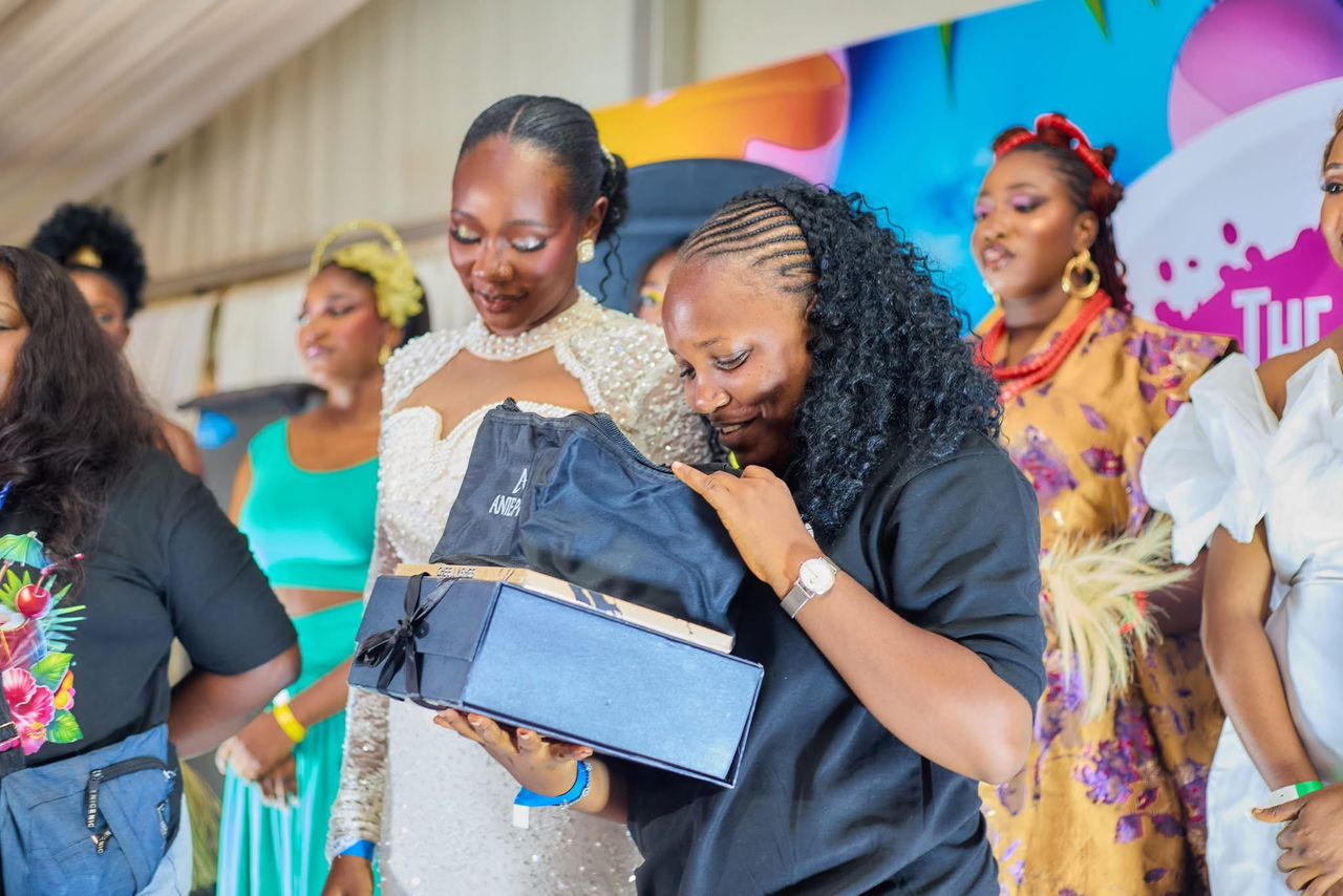 Winning artist receiving her prize box on stage