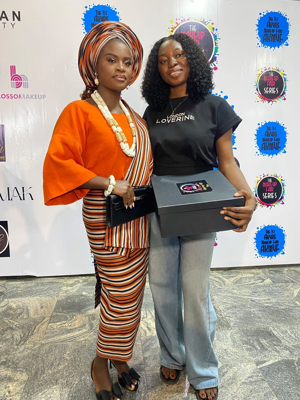 Artist with her prize box at the Akure Makeup Fair